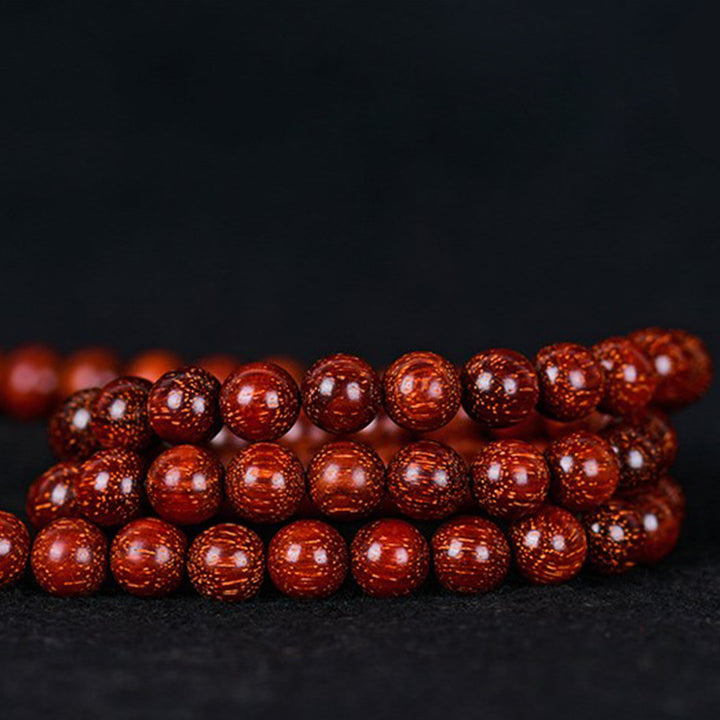 Braccialetto di equilibrio in legno di sandalo rosso con foglia piccola tibetana Buddha Stones