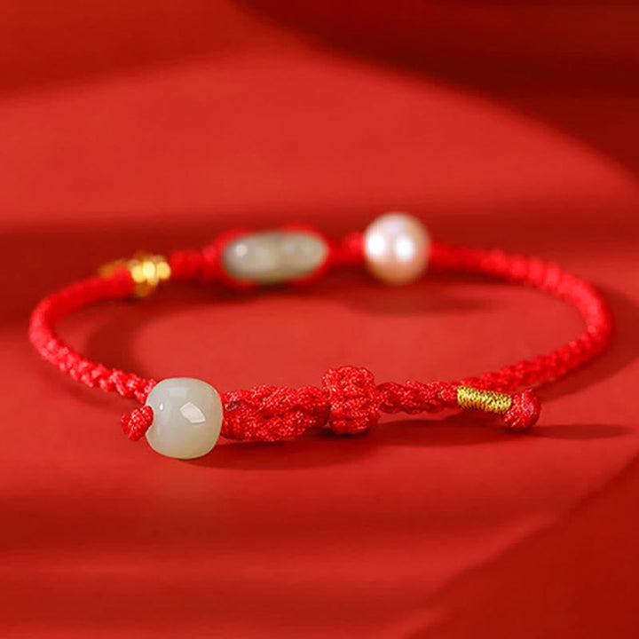 Braccialetto in corda rossa con moneta di rame e giada di Hetian dell'anno del coniglio in argento sterling 925