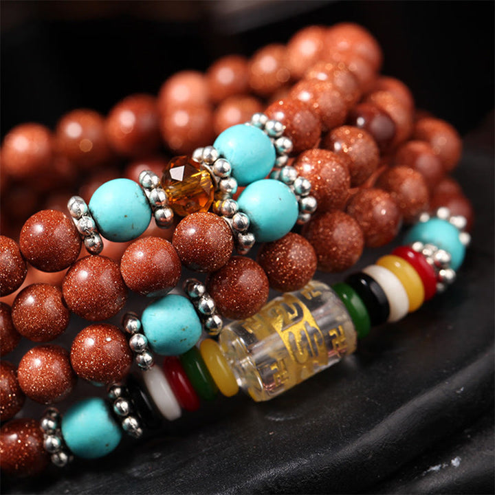 Buddha Stones 108 Mala Beads Goldstone Om Mani Padme Hum Swastika Braccialetto di Fiducia