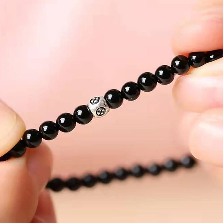 Bracciale Buddha Stones in ossidiana nera naturale e quarzo fumé per la forza di purificazione
