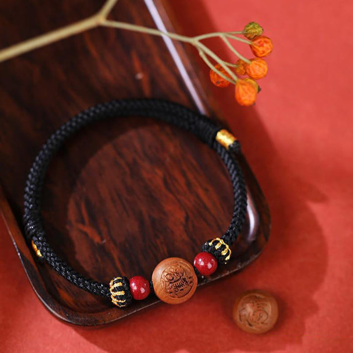 Braccialetto della ricchezza in cinabro intagliato con carattere dello zodiaco cinese Fu in legno di pesca naturale Buddha Stones