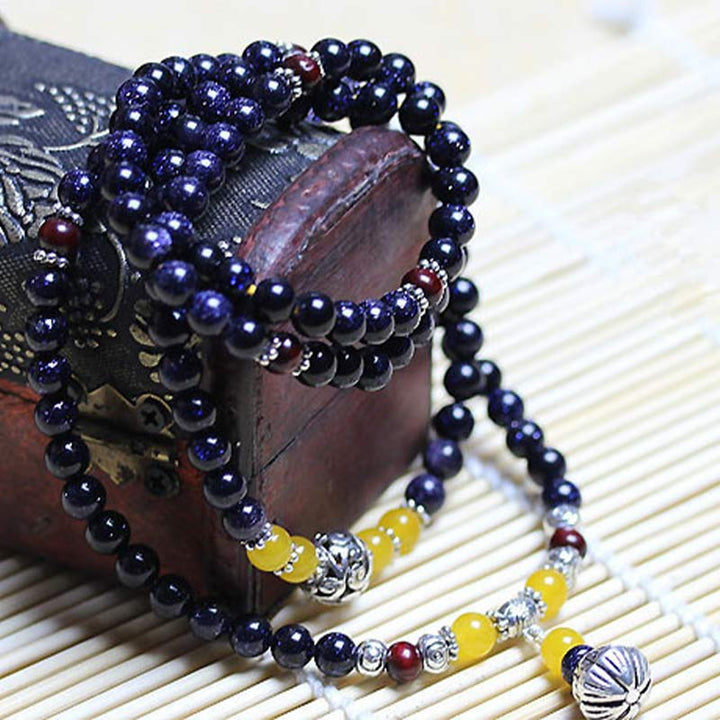 Braccialetto Mala con ciondolo di ricchezza in arenaria blu Buddha Stones