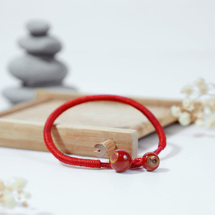 Braccialetto in ceramica con corda rossa portafortuna FengShui Buddha Stones