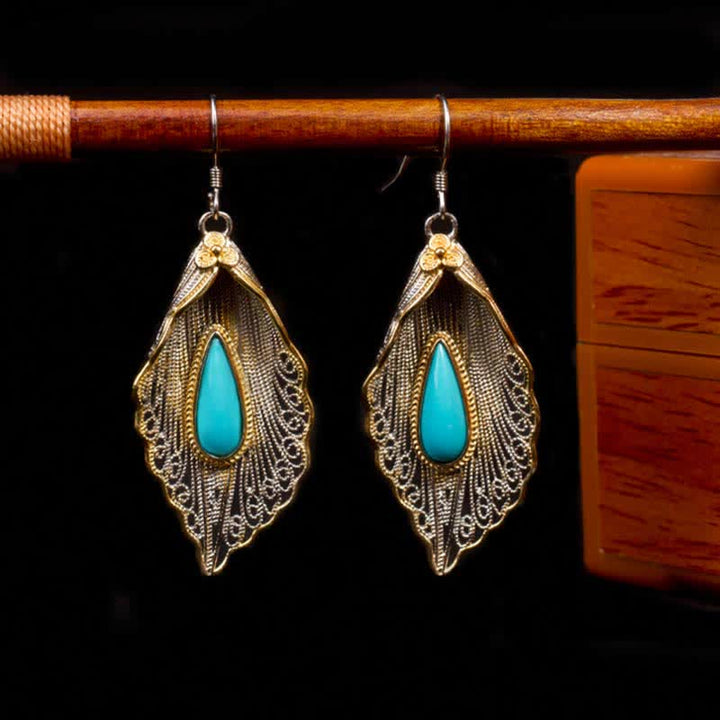 Orecchini pendenti con motivo a foglia di Bodhi in argento sterling 925 con Buddha Stones e turchese
