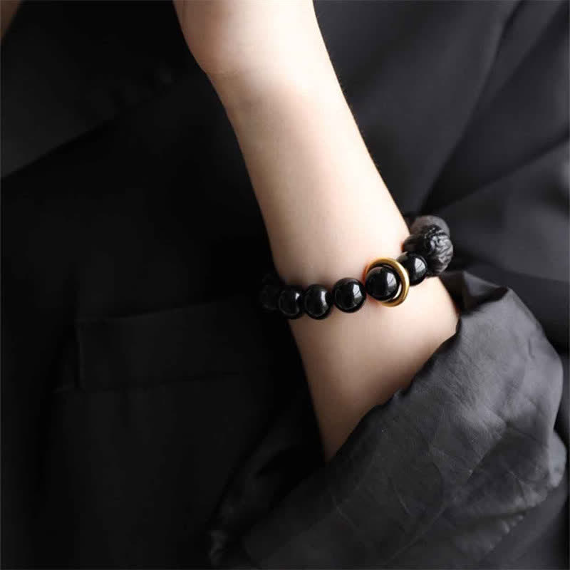 Bracciale in ossidiana nera, argento lucido e forza del leone