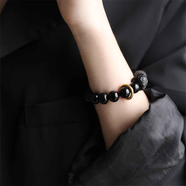 Bracciale in ossidiana nera, argento lucido e forza del leone