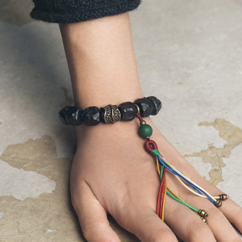 Bracciale Mala da polso con nappa in legno di Buddha Stones tibetano e rame della pace