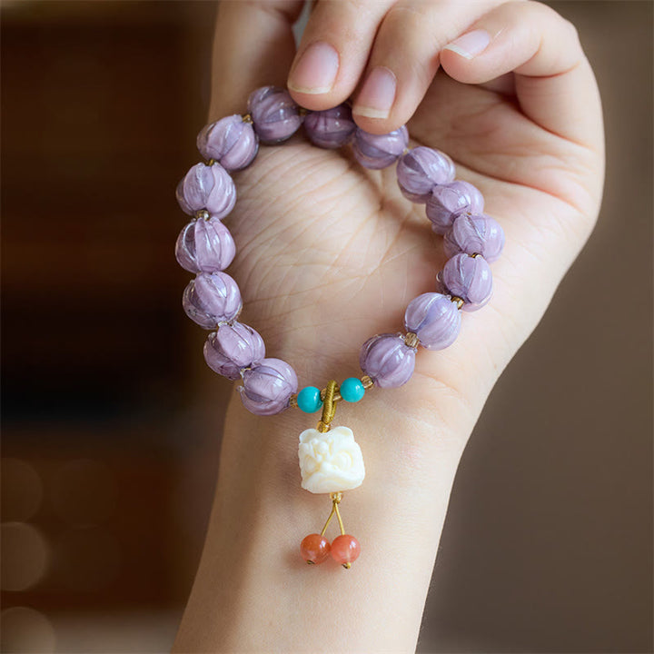 Braccialetto dell'illuminazione con ciondolo leone danzante avorio, perline di vetro Liuli, motivo loto, fluorite e Buddha Stones