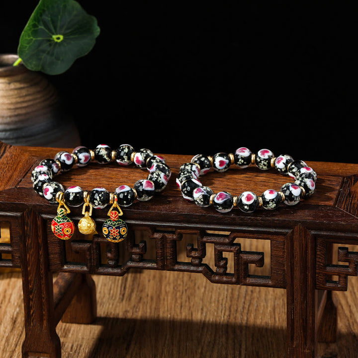 Braccialetto di perline di vetro fluorescente luminoso Liuli con cuore rosa della famiglia di bestie che ingoiano Buddha Stones
