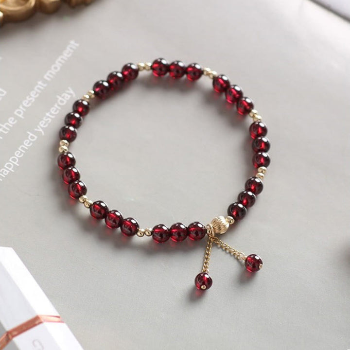 Bracciale Buddha Stones in oro 14K con granato naturale e calma
