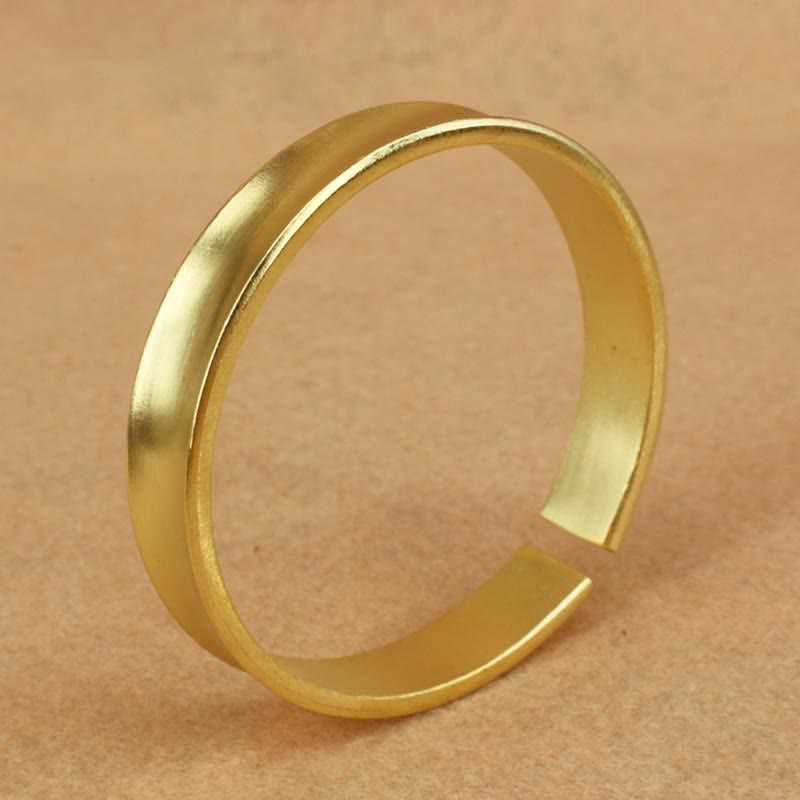 Bracciale rigido in rame con simbolo di ricchezza e fortuna
