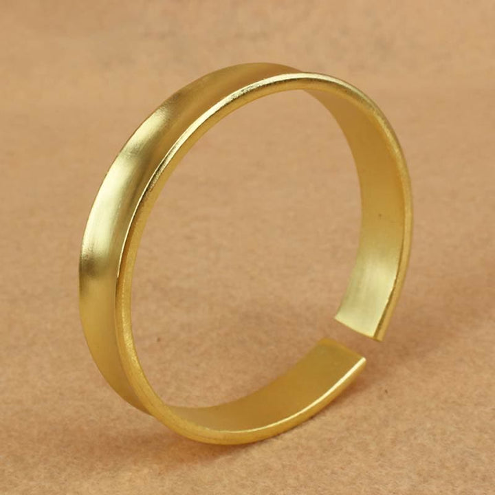 Bracciale rigido in rame con simbolo di ricchezza e fortuna