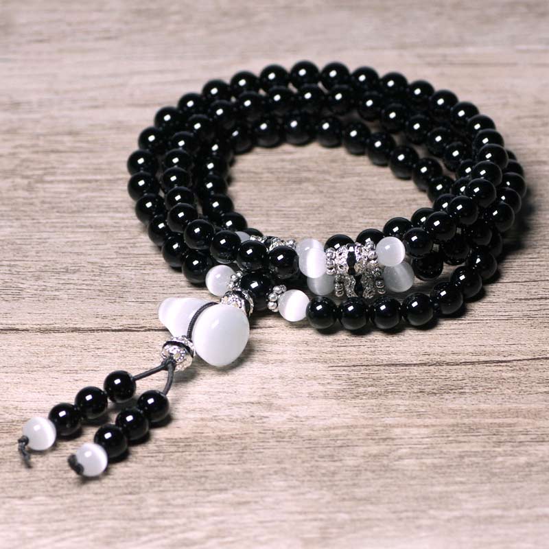 Braccialetto di meditazione con perline di cristallo bianco e onice nero Buddha Stones