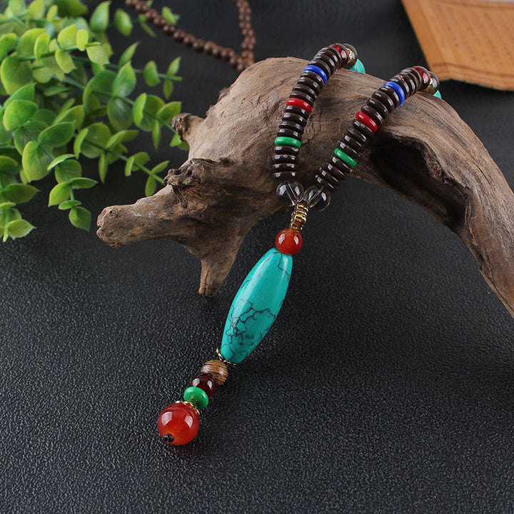 Collana con ciondolo in pietra turchese, pietra di legno di wenge, protezione e calma Buddha Stones