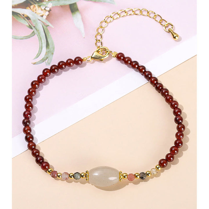 Bracciale Buddha Stones con perline di giada, tormalina e granato