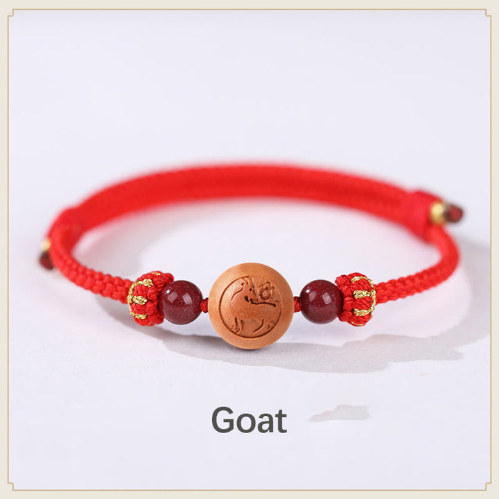 Braccialetto della ricchezza in cinabro intagliato con carattere dello zodiaco cinese Fu in legno di pesca naturale Buddha Stones