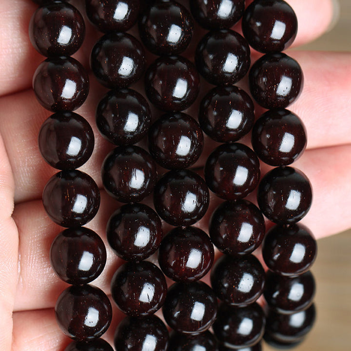 Braccialetto di protezione con nodo cinese in legno di sandalo rosso con piccola foglia e stella d'oro Buddha Stones
