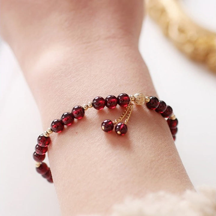 Bracciale Buddha Stones in oro 14K con granato naturale e calma