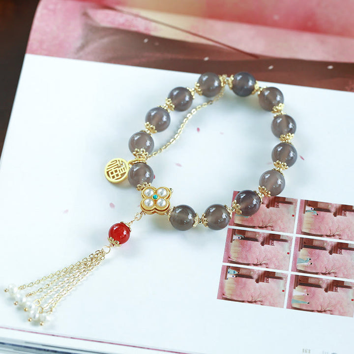 Braccialetto di equilibrio con nappa di perle di carattere Fu in agata grigia naturale Buddha Stones