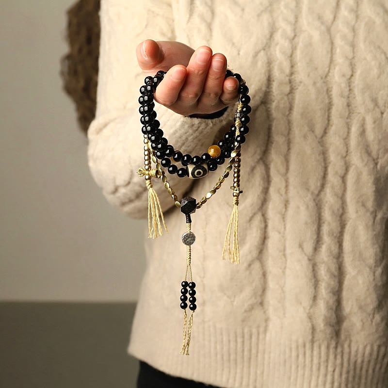 Buddha Stones Tibetano 108 Mala Beads Onice Nero Tre Occhi Dzi Beads Bracciale di Protezione