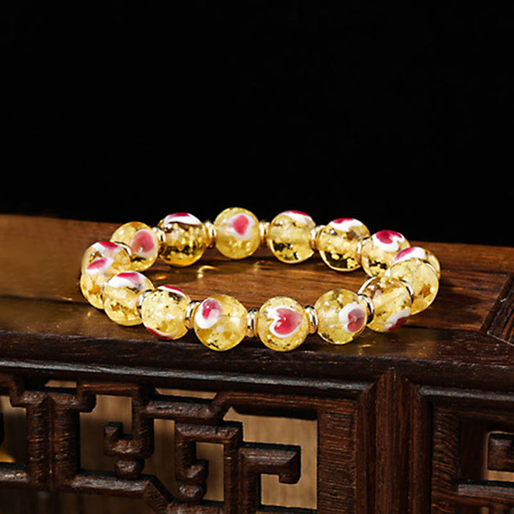 Braccialetto di perline di vetro fluorescente luminoso Liuli con cuore rosa della famiglia di bestie che ingoiano Buddha Stones