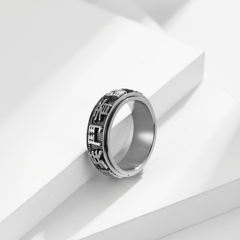 Anello girevole in acciaio al titanio con parole in equilibrio e calma