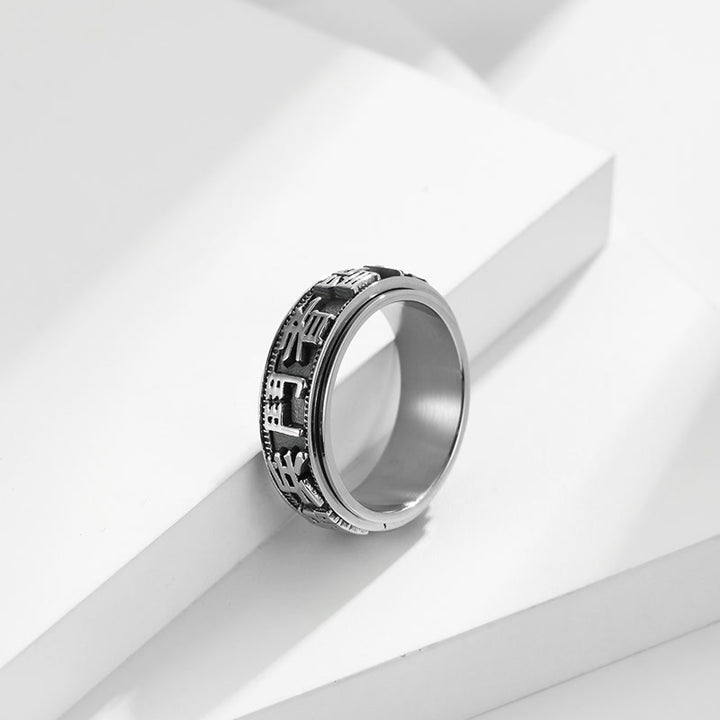 Anello girevole in acciaio al titanio con parole in equilibrio e calma