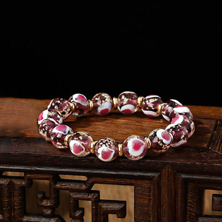 Braccialetto di perline di vetro fluorescente luminoso Liuli con cuore rosa della famiglia di bestie che ingoiano Buddha Stones