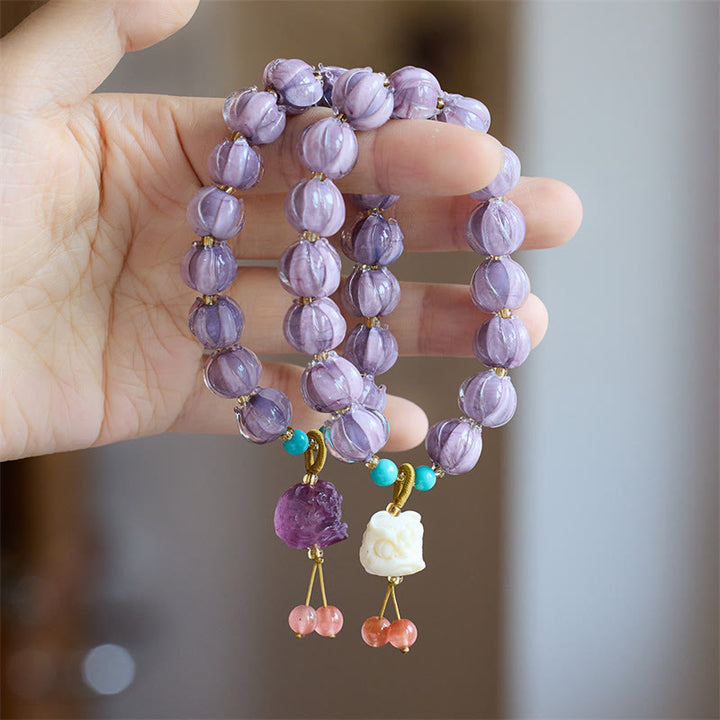Braccialetto dell'illuminazione con ciondolo leone danzante avorio, perline di vetro Liuli, motivo loto, fluorite e Buddha Stones