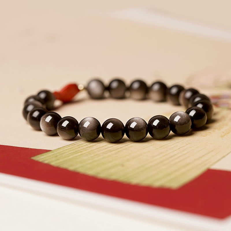 Braccialetto di protezione lenitiva con pesce koi, ossidiana, cinabro, argento naturale e Buddha Stones