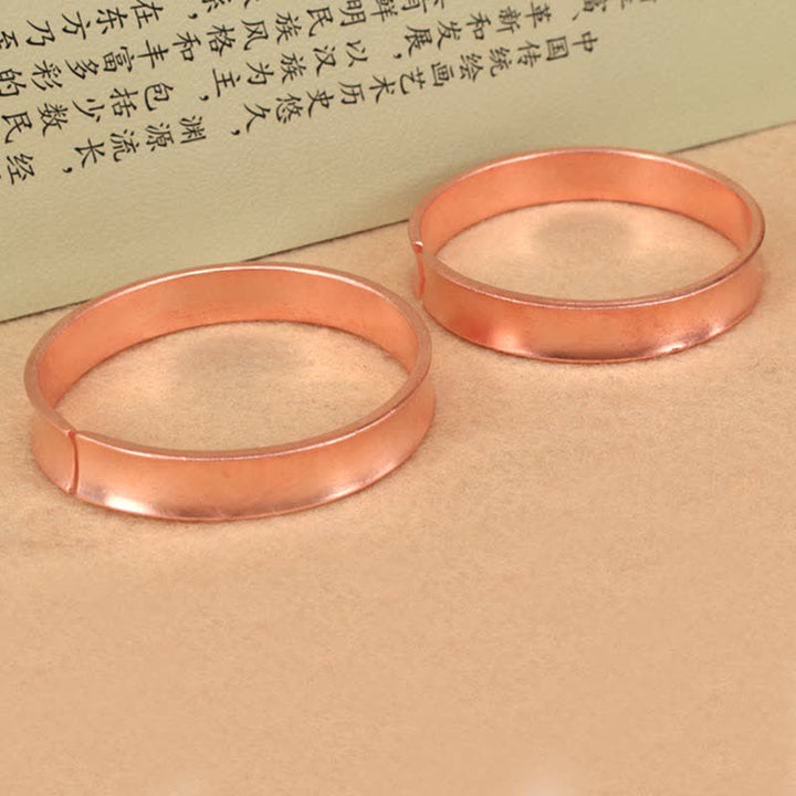 Bracciale rigido in rame con simbolo di ricchezza e fortuna