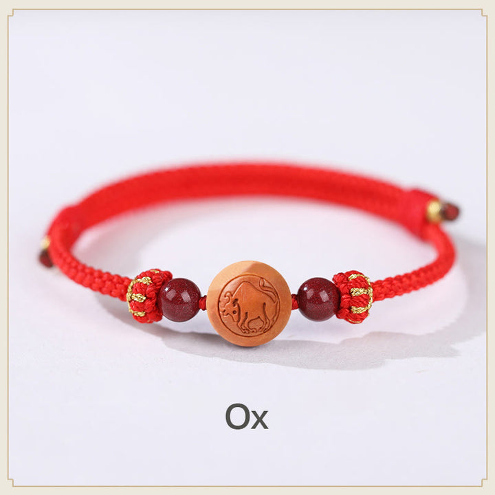 Braccialetto della ricchezza in cinabro intagliato con carattere dello zodiaco cinese Fu in legno di pesca naturale Buddha Stones