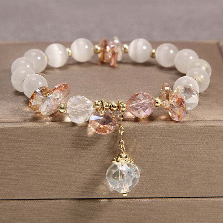 Braccialetto con ciondolo di pace in cristallo rosa con occhio di gatto Buddha Stones