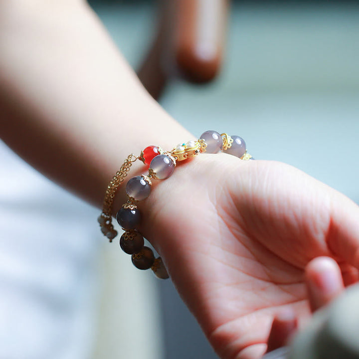 Braccialetto di equilibrio con nappa di perle di carattere Fu in agata grigia naturale Buddha Stones
