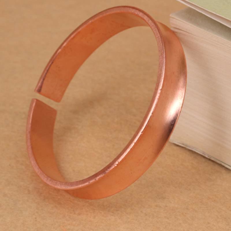 Bracciale rigido in rame con simbolo di ricchezza e fortuna