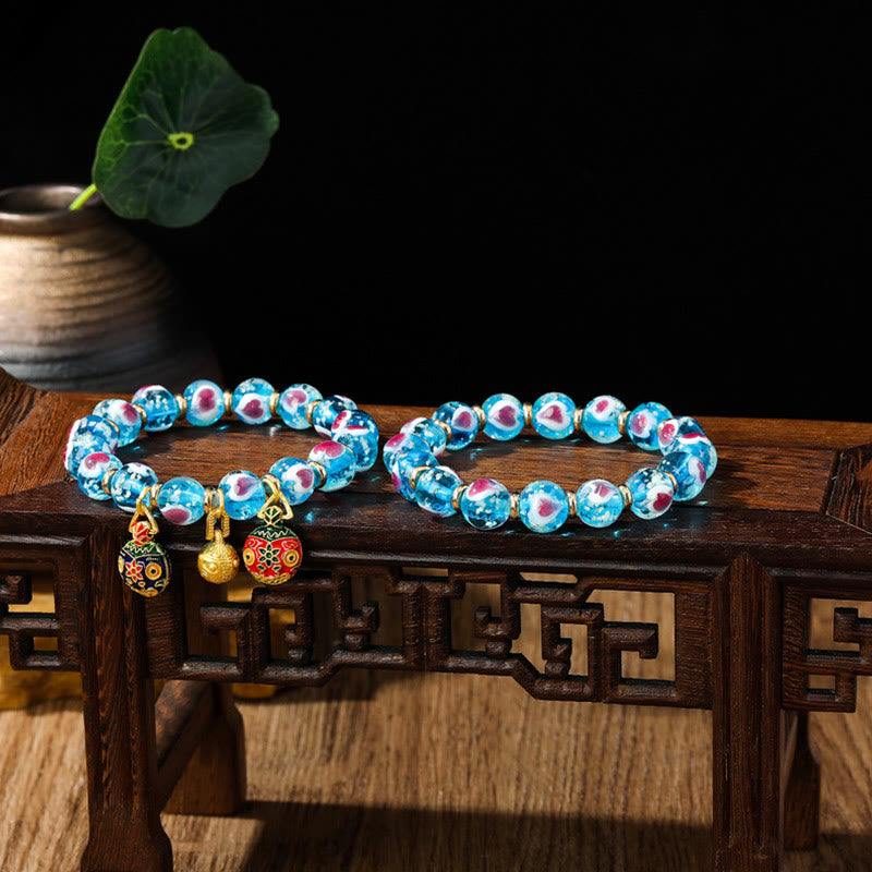 Braccialetto di perline di vetro fluorescente luminoso Liuli con cuore rosa della famiglia di bestie che ingoiano Buddha Stones