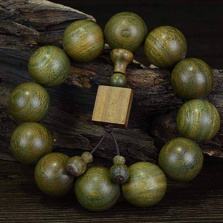 Braccialetto di cura in legno di sandalo verde tibetano Buddha Stones
