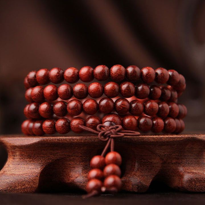 Braccialetto di meditazione Mala con 108 perle di legno di sandalo rosso e foglie piccole tibetane Buddha Stones