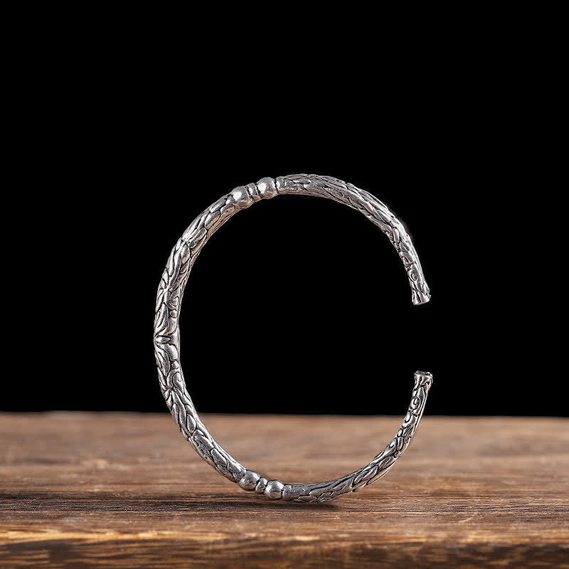Bracciale rigido con polsino con motivo a drago inciso e bilanciamento