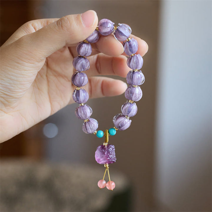 Braccialetto dell'illuminazione con ciondolo leone danzante avorio, perline di vetro Liuli, motivo loto, fluorite e Buddha Stones