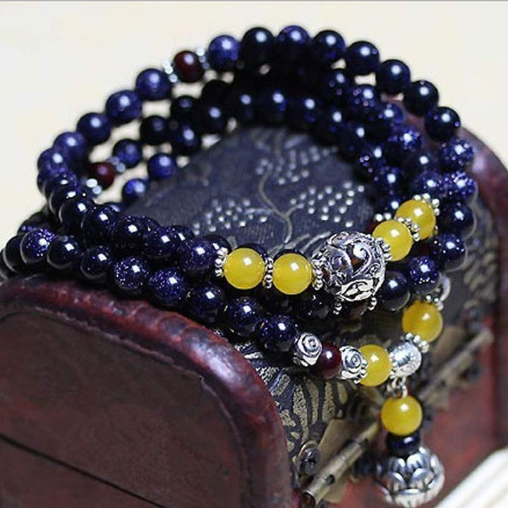 Braccialetto Mala con ciondolo di ricchezza in arenaria blu Buddha Stones