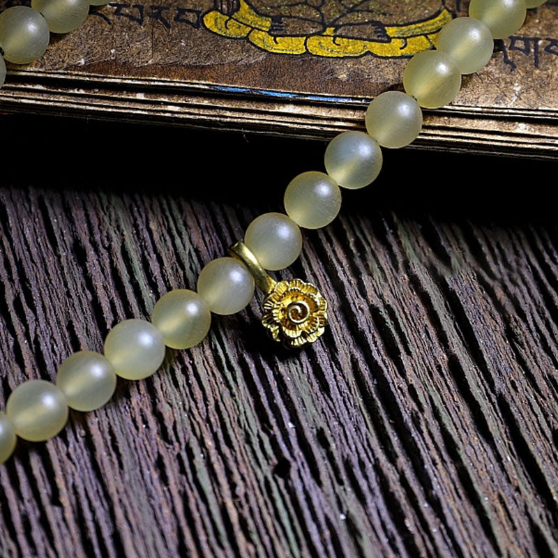 Braccialetto della fortuna in ambra e corno di pecora del Tibet con 108 perle di Mala Buddha Stones