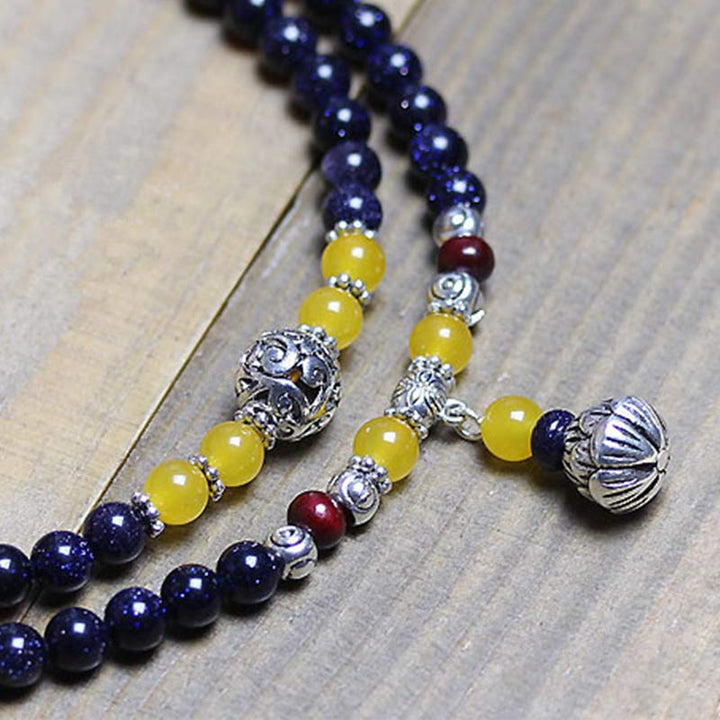 Braccialetto Mala con ciondolo di ricchezza in arenaria blu Buddha Stones