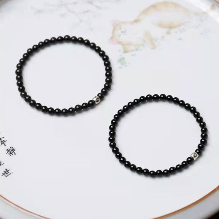 Bracciale Buddha Stones in ossidiana nera naturale e quarzo fumé per la forza di purificazione