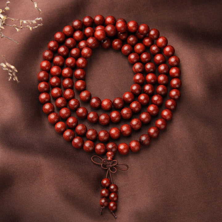 Braccialetto di meditazione Mala con 108 perle di legno di sandalo rosso e foglie piccole tibetane Buddha Stones