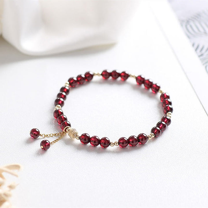 Bracciale Buddha Stones in oro 14K con granato naturale e calma