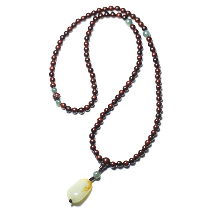 Braccialetto di meditazione Mala in giada di sandalo rosso con piccole foglie tibetane di Buddha Stones