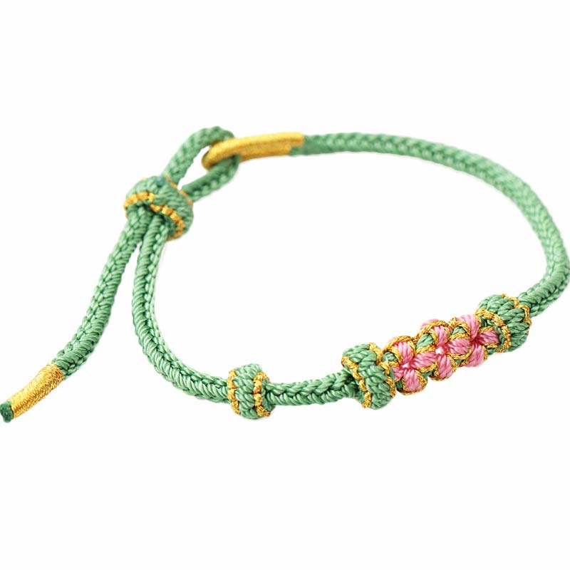 Braccialetto fatto a mano Buddha Stones con tre fiori di pesco e otto fili di corda intrecciata
