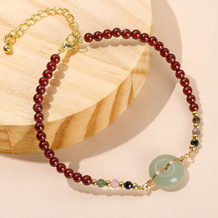 Braccialetto di perline con fibbia della pace in granato naturale Buddha Stones
